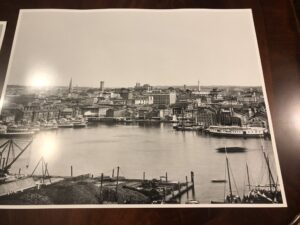 A black and white photo of the harbor in an old town.