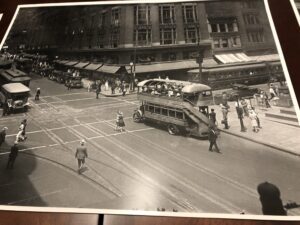 A black and white photo of people crossing the street.
