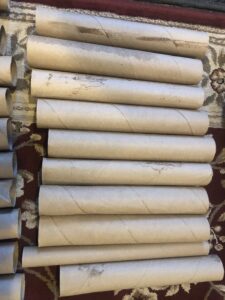 A bunch of rolled up toilet paper sitting on top of each other.