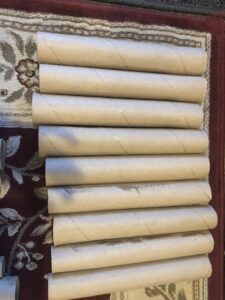 A bunch of rolled up paper towels on the wall