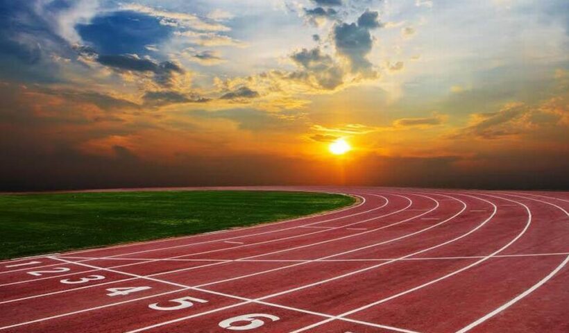 A track with the sun setting behind it.