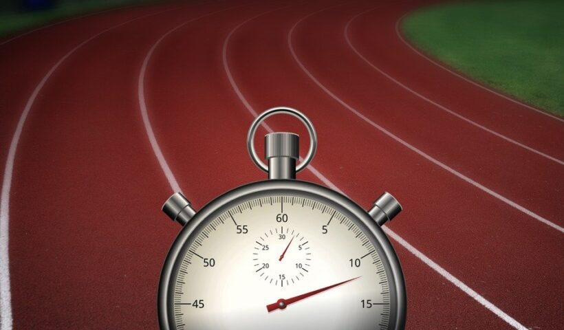 A stopwatch on the track of an outdoor stadium.