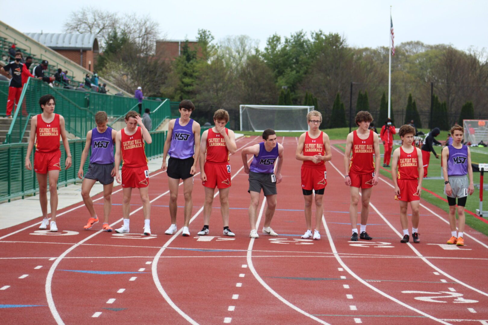 A group of young men standing on top of a track.