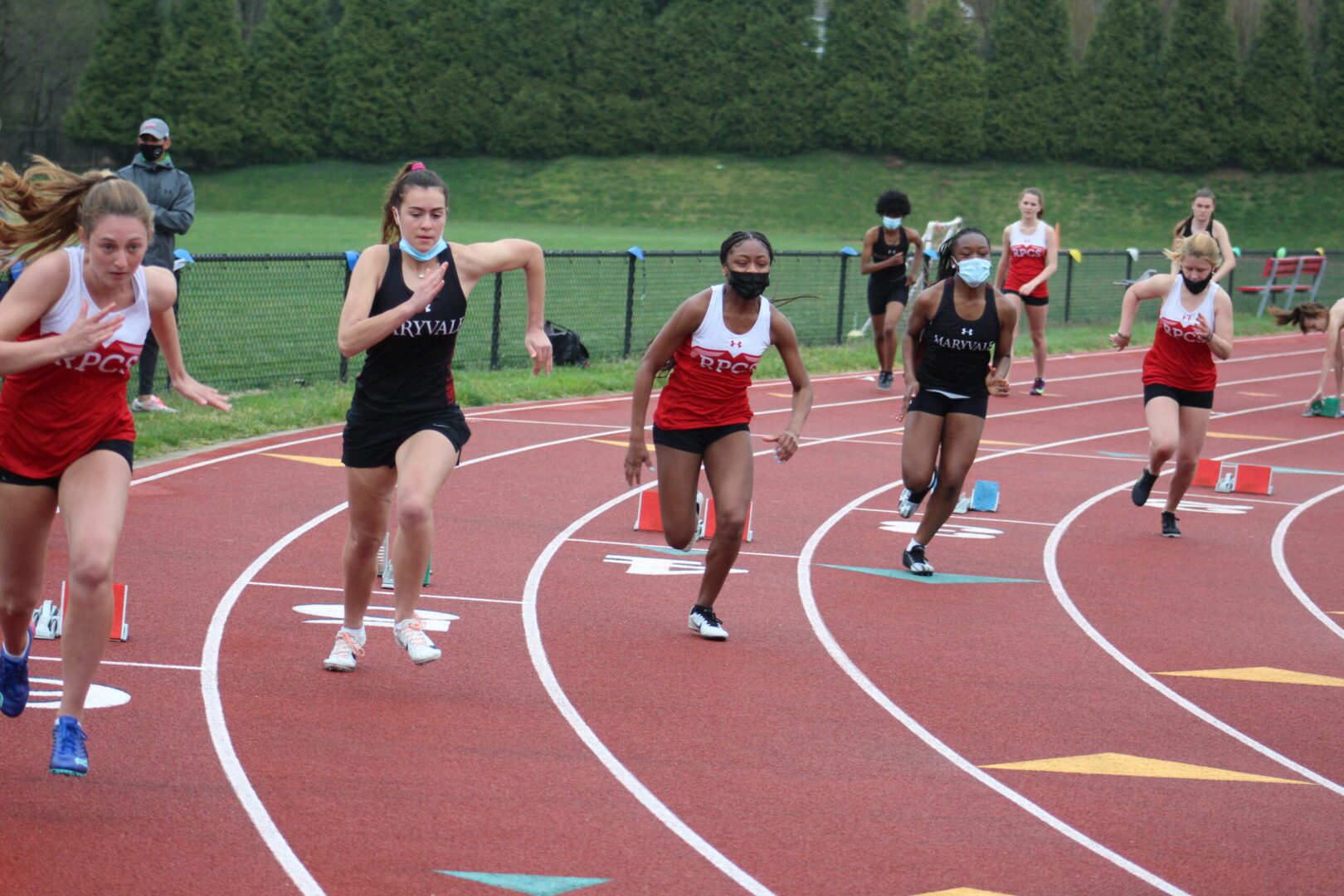 A group of people running on a track