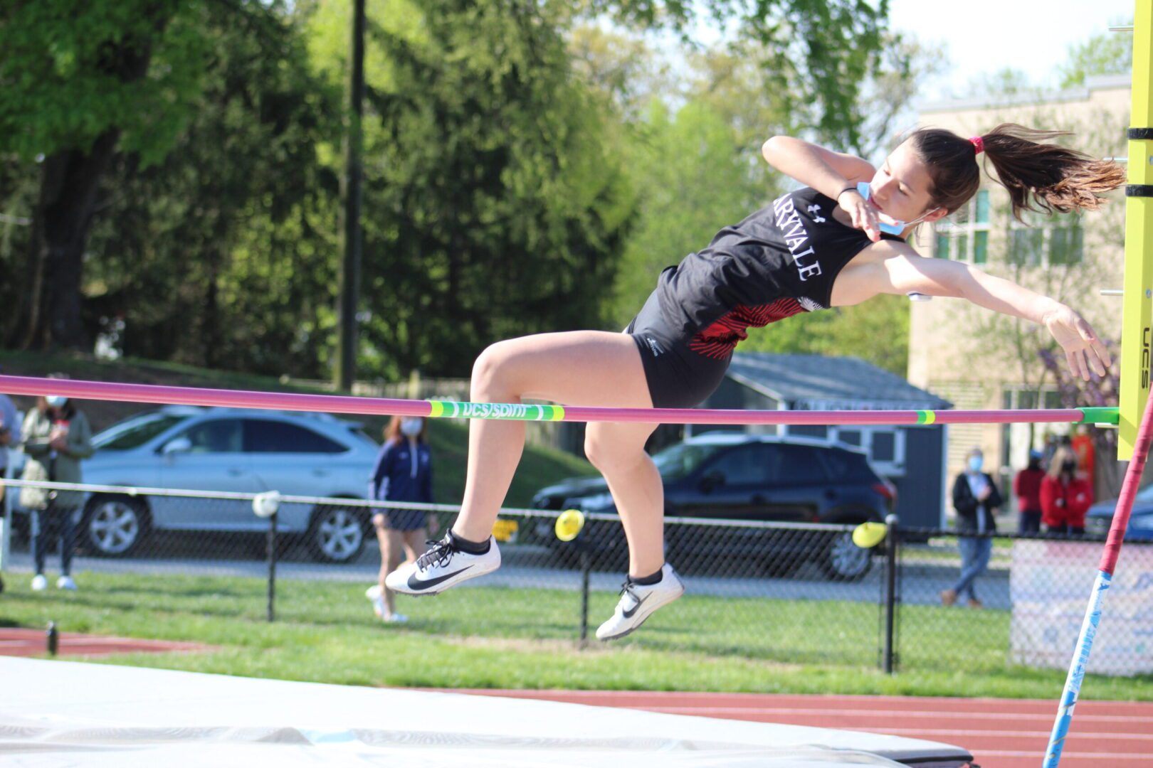 A person jumping over the bar in a track and field event.