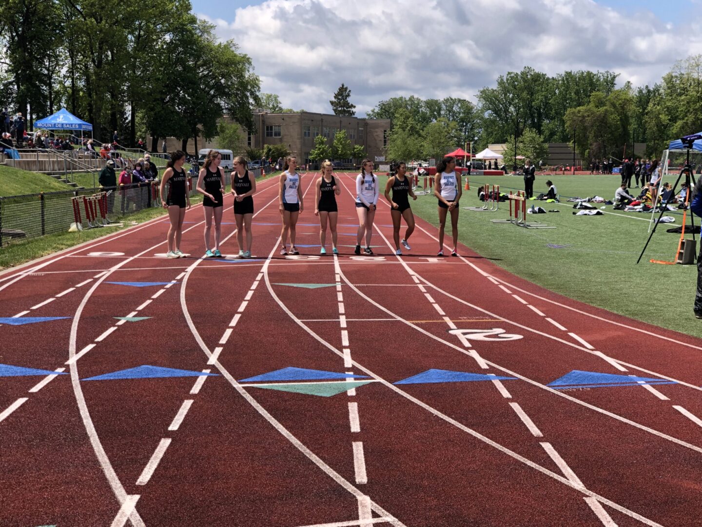 A group of people standing on top of a track.