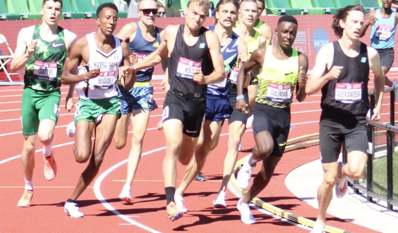 A group of men running on a track.