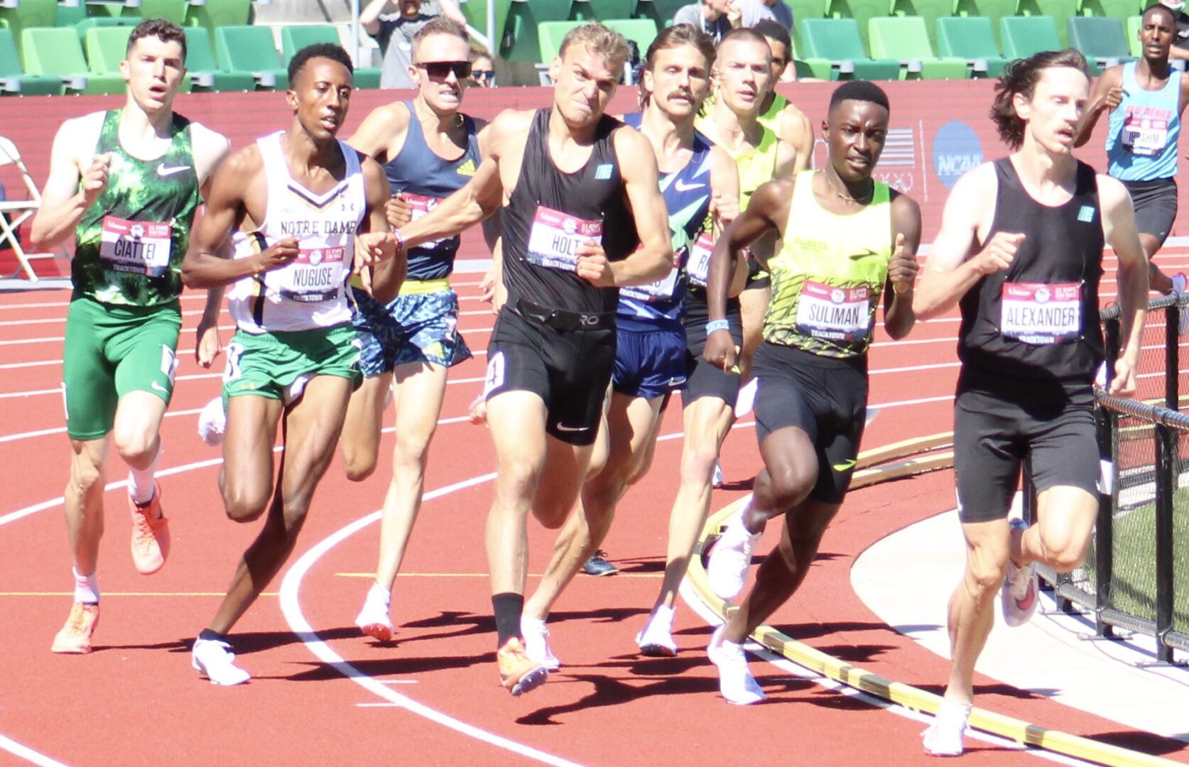 A group of men running on a track.