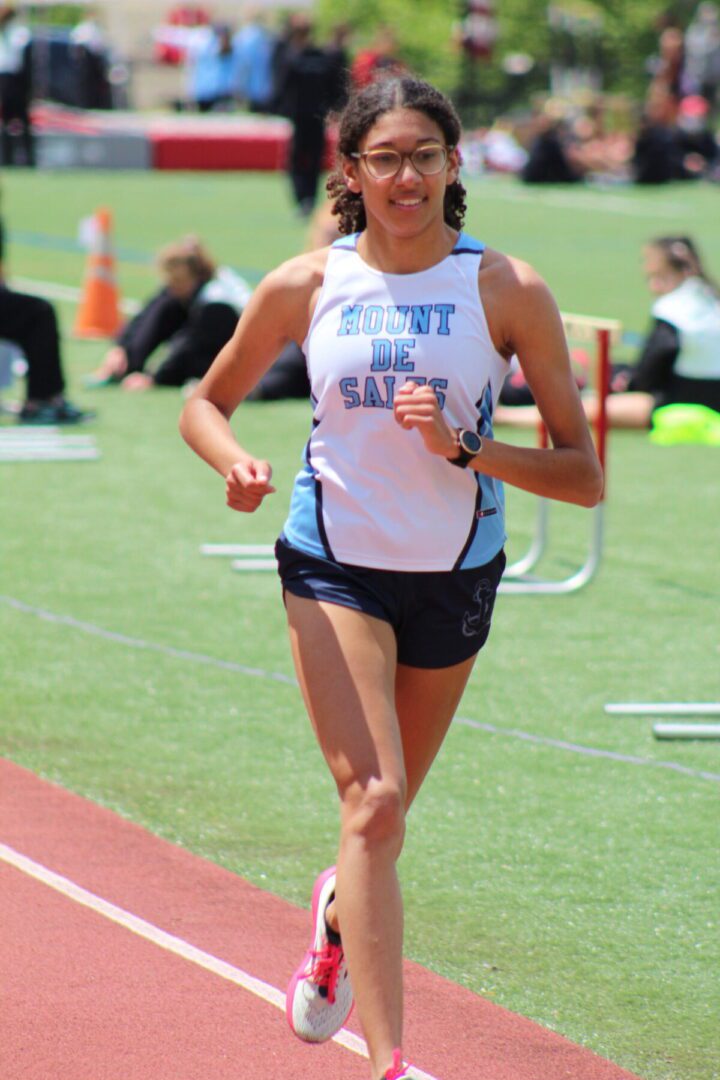 A woman running on the track in a race.