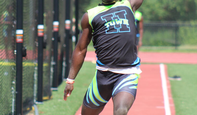 A man is running on the track in his shorts