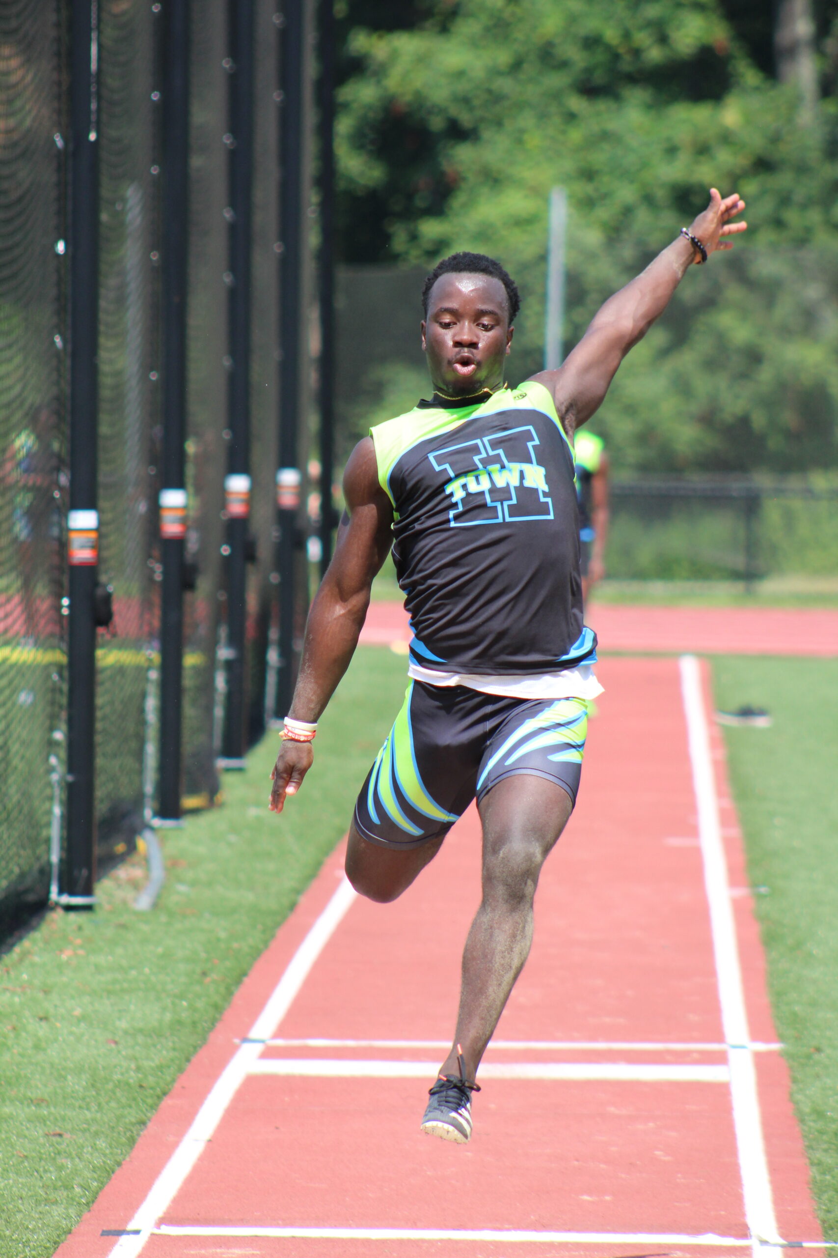 A man is running on the track in his shorts