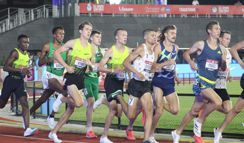 A group of men running on the track