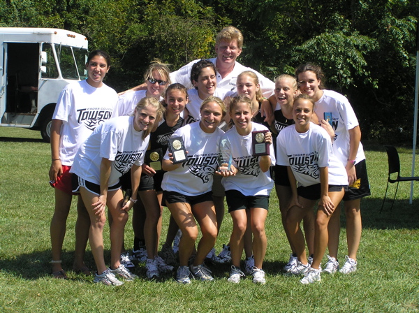 A group of girls in white shirts and black shorts.