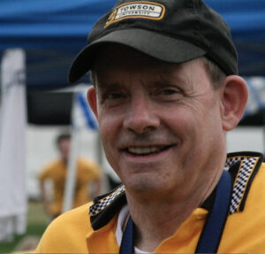 A man wearing an orange and black hat.