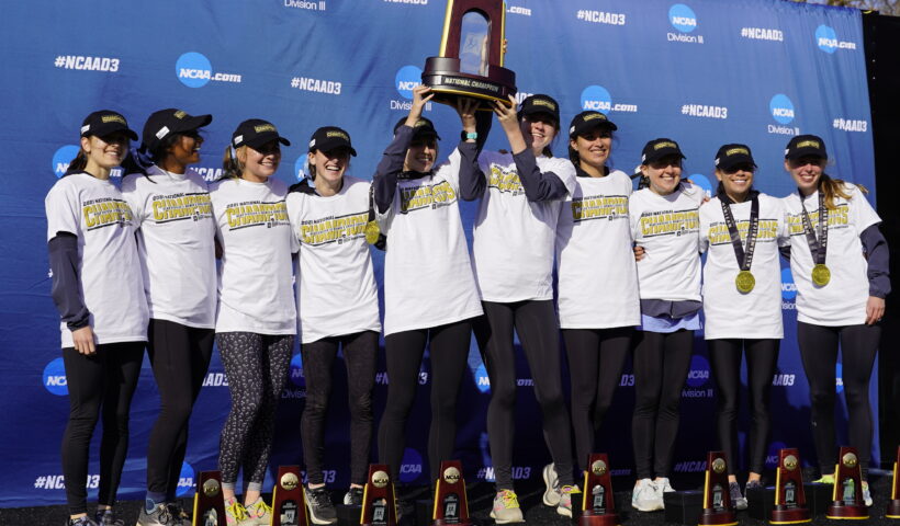 A group of women holding up trophies and posing for the camera.