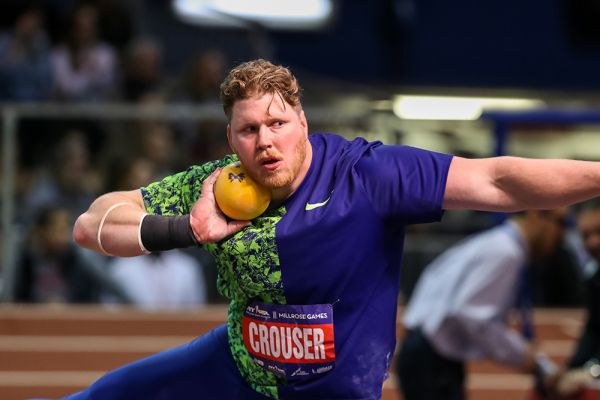 A man throwing an orange at the olympics.