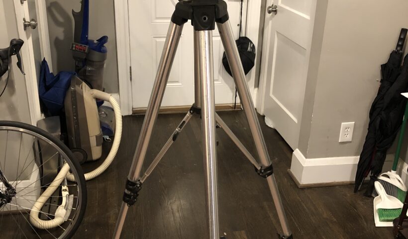 A tripod is standing in front of the television.