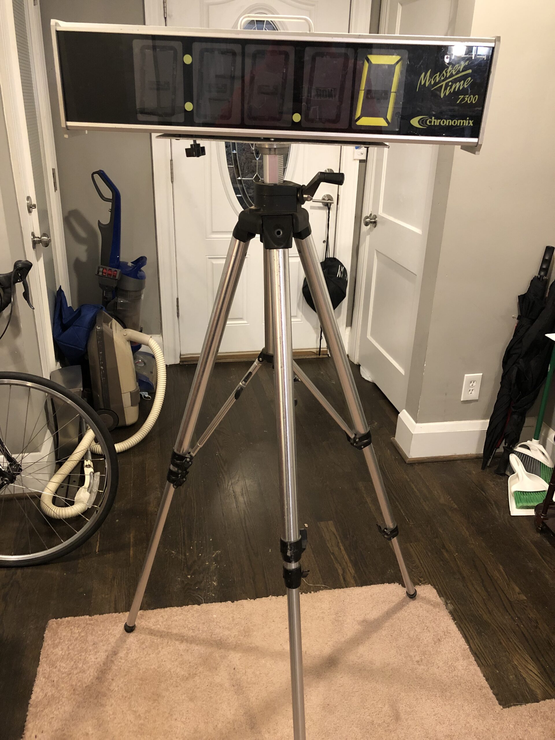 A tripod is standing in front of the television.