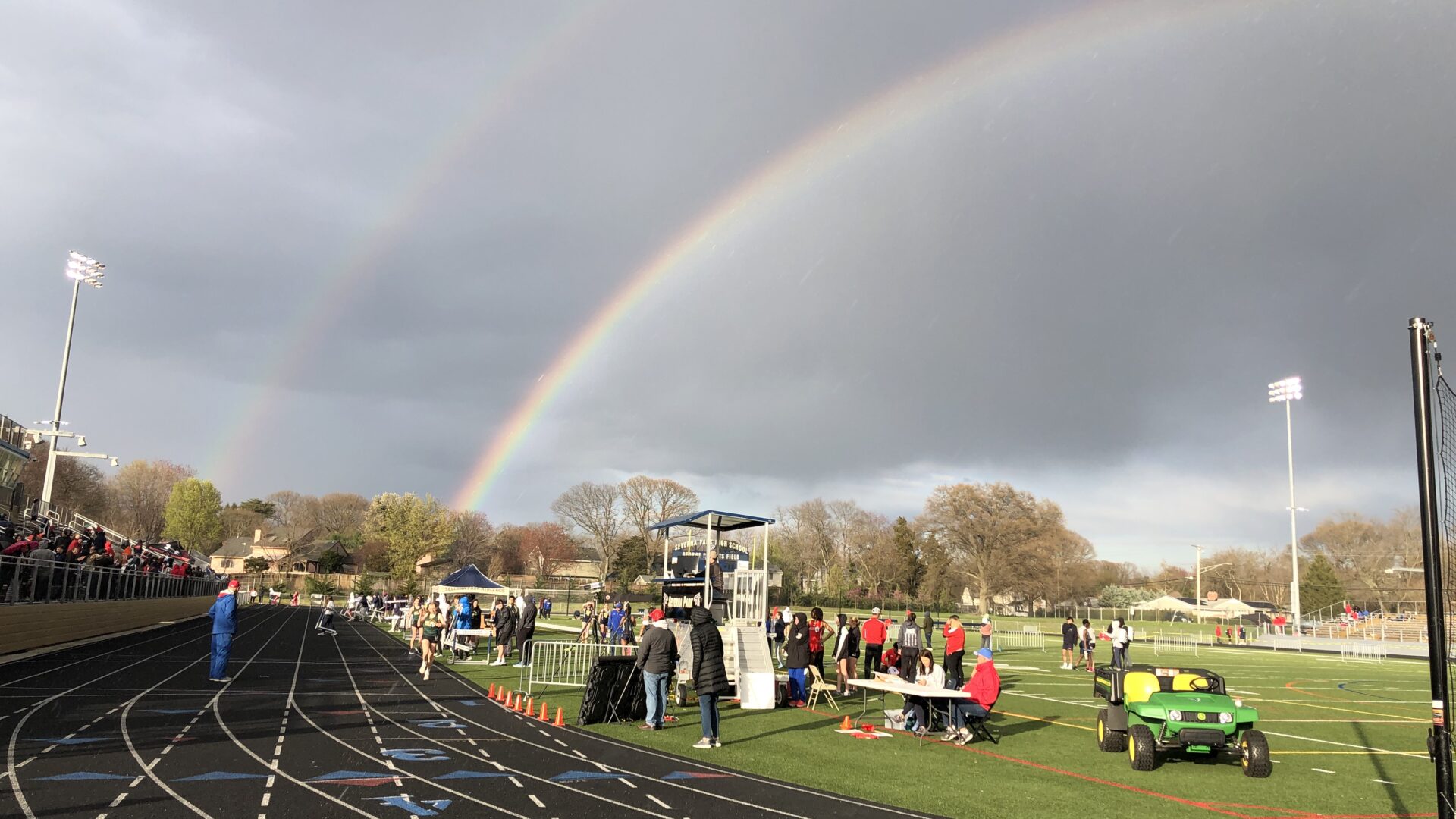 A rainbow over the track at a sports field.