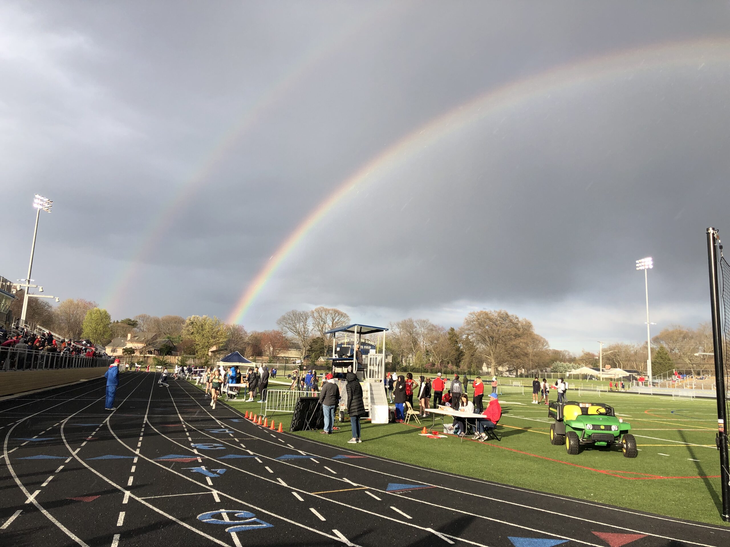A rainbow over the track at a sports field.