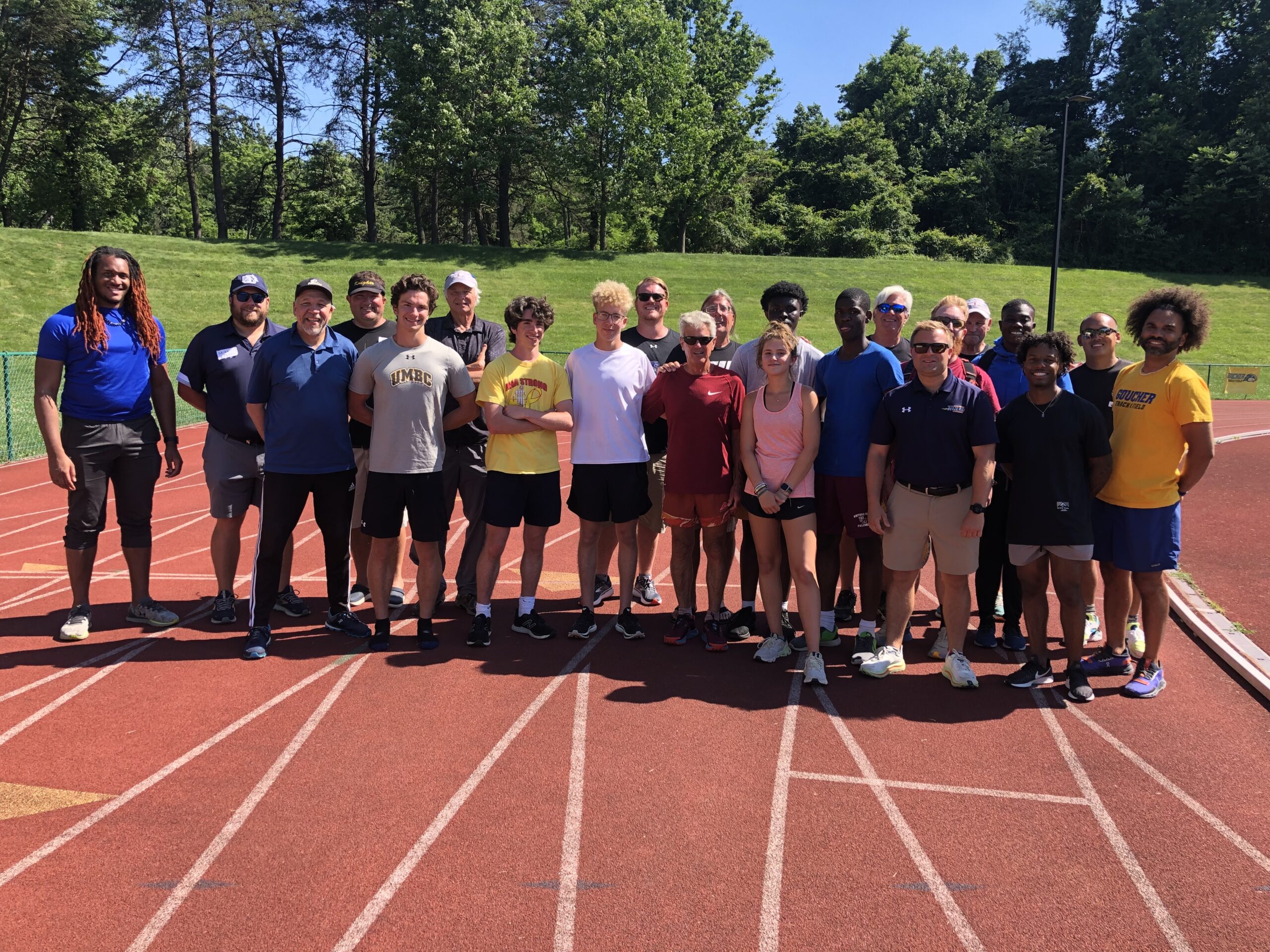 A group of people standing on top of a track.