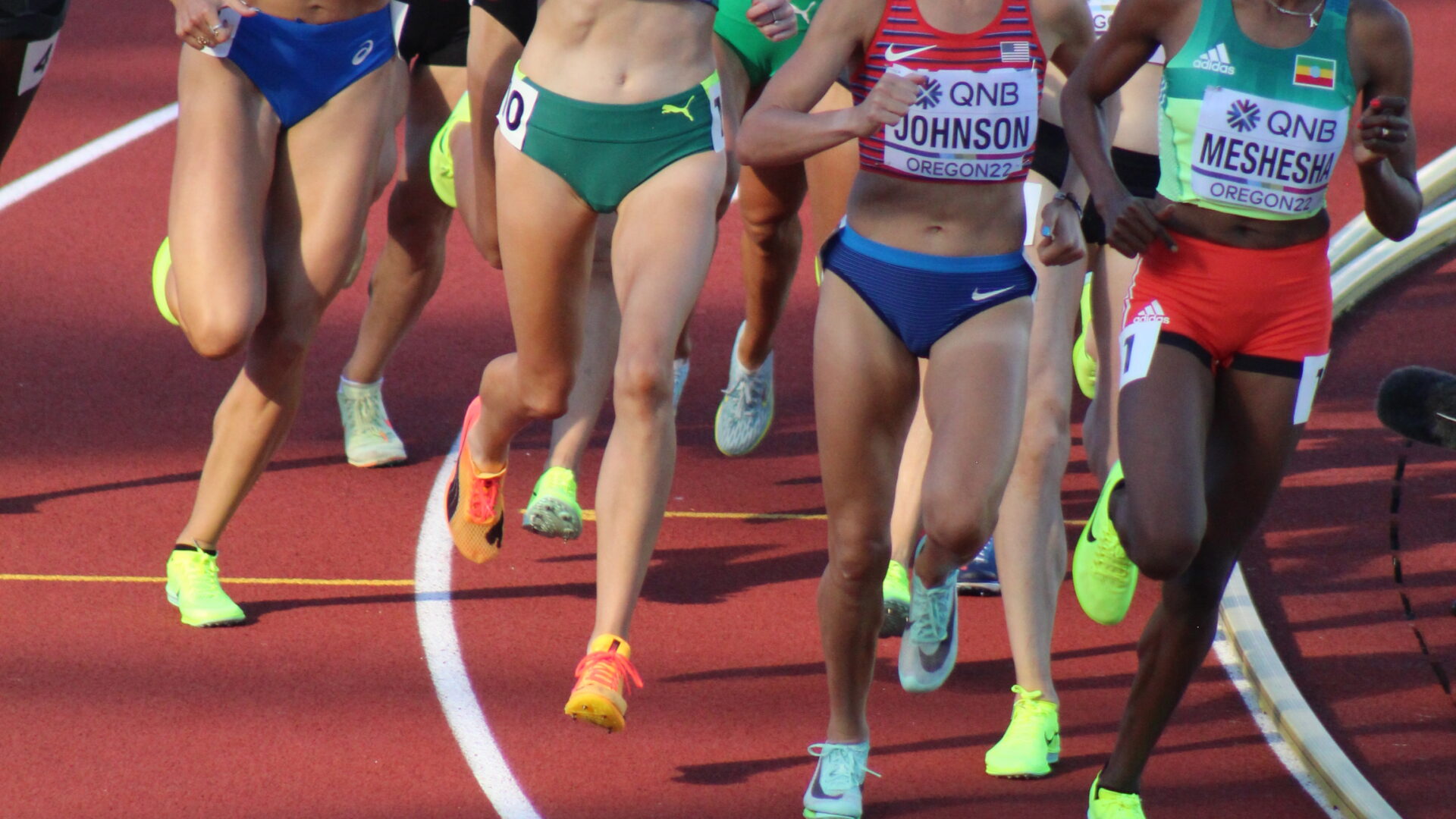 A group of women running on a track.