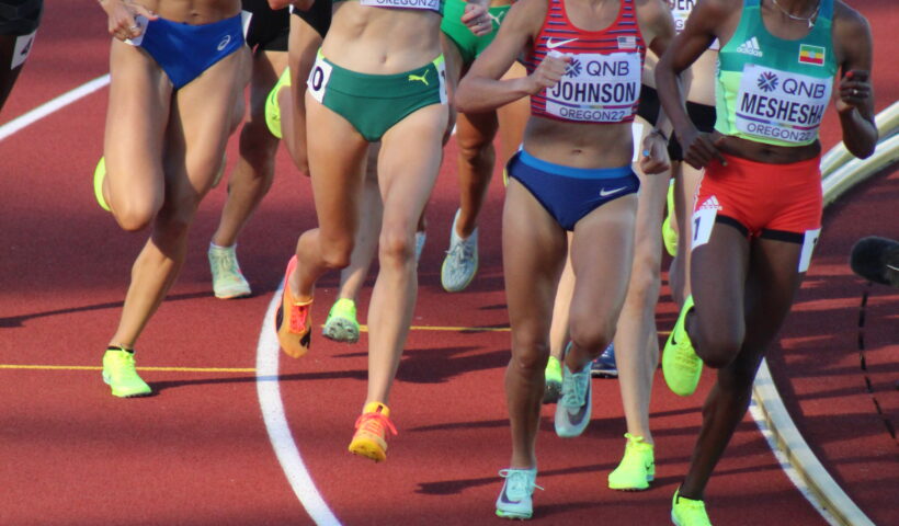 A group of women running on a track.