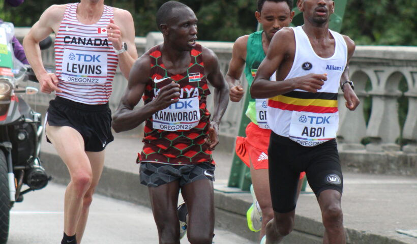 A group of men running on the street.