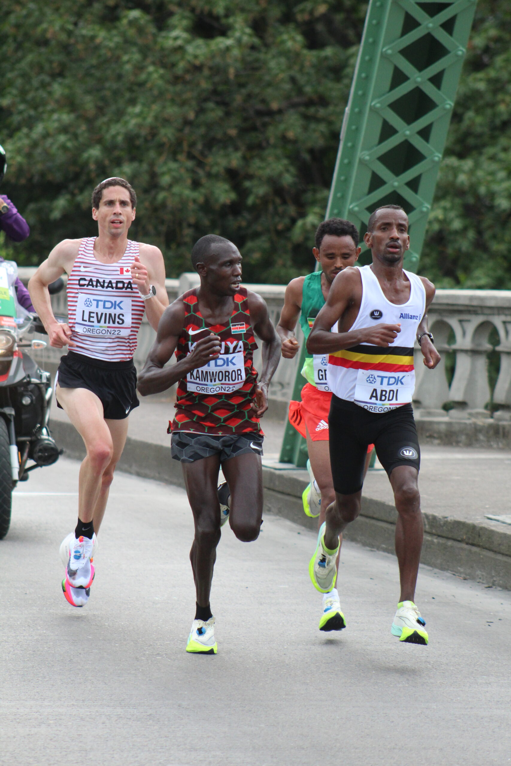 A group of men running on the street.