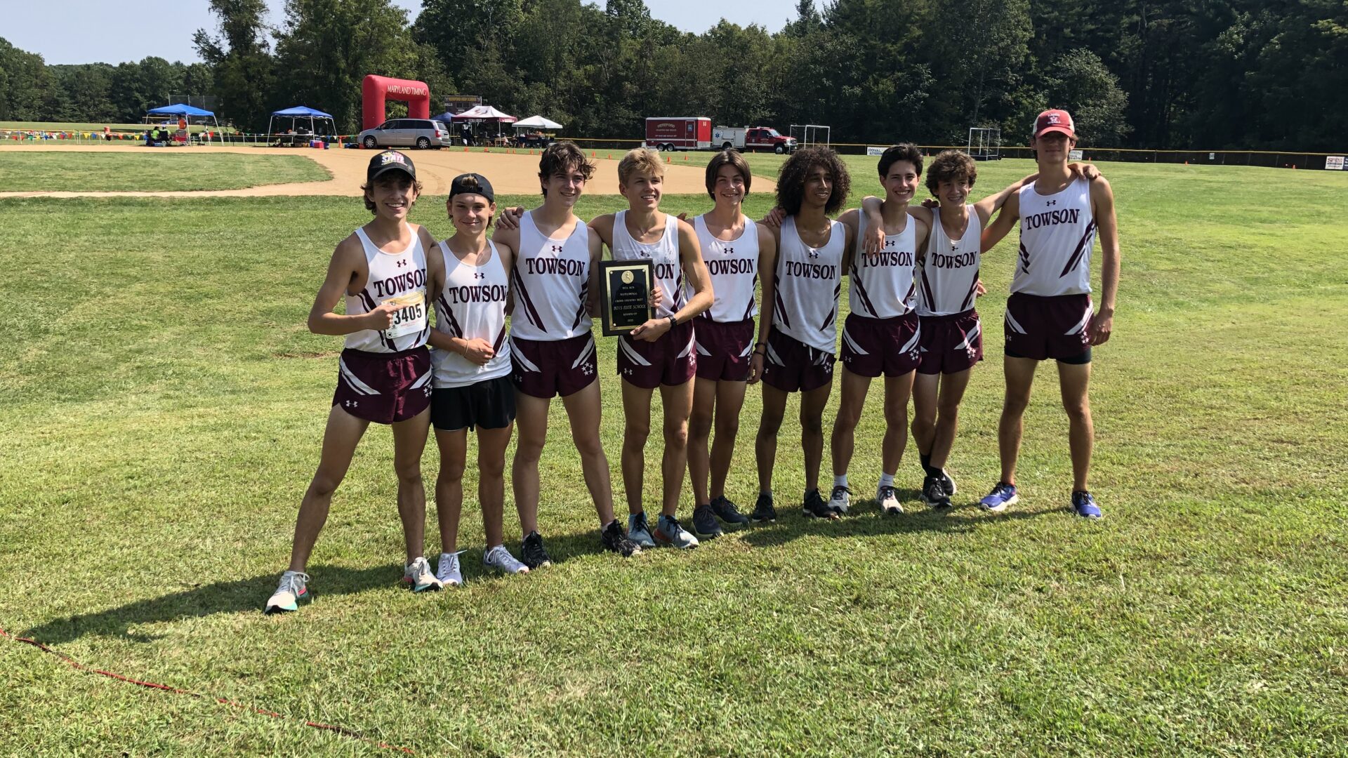 A group of people standing on top of a grass covered field.
