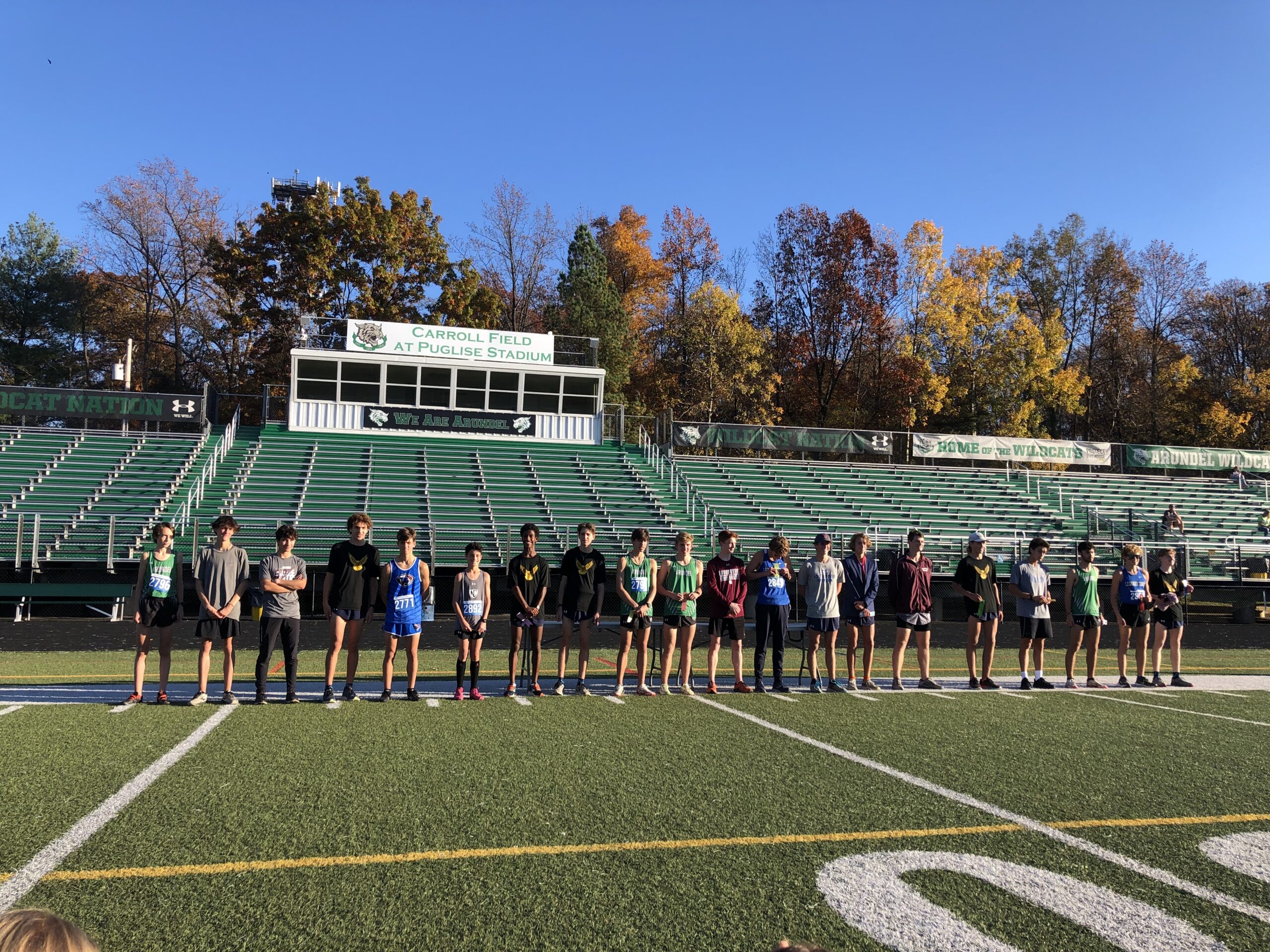 A group of people standing on top of a field.