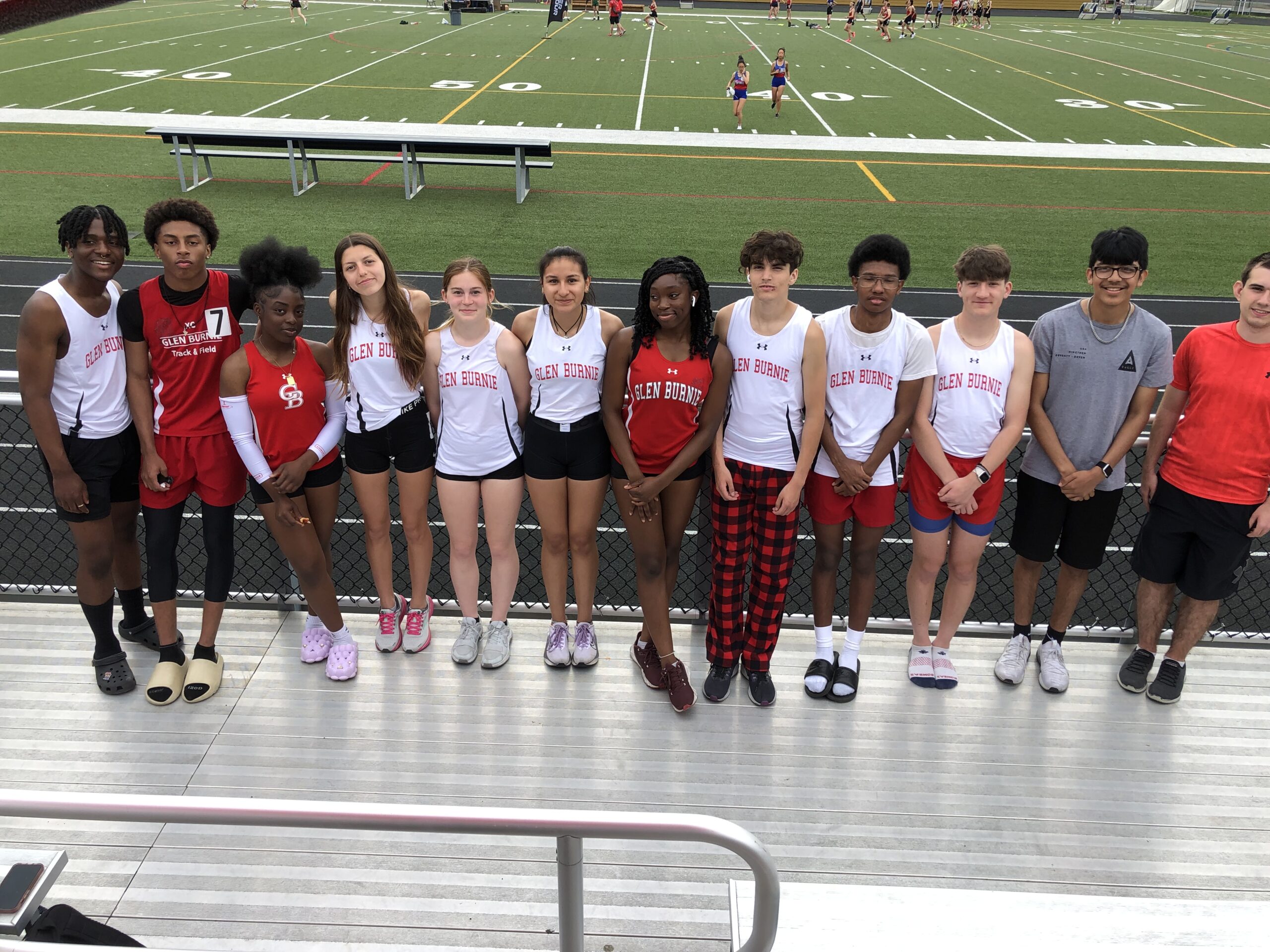 A group of young people standing on top of a field.