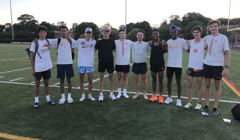 A group of men standing on top of a soccer field.