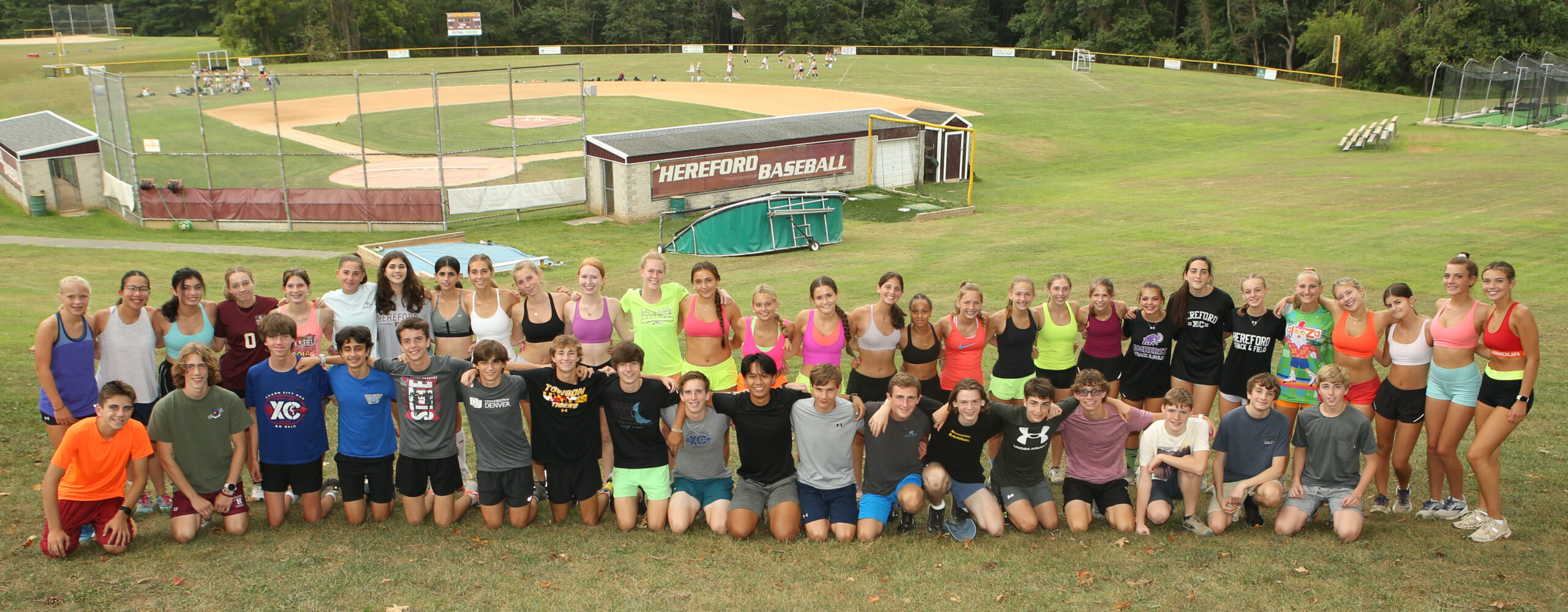 A group of people that are standing in the grass.