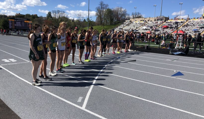 A group of people standing on top of a track.