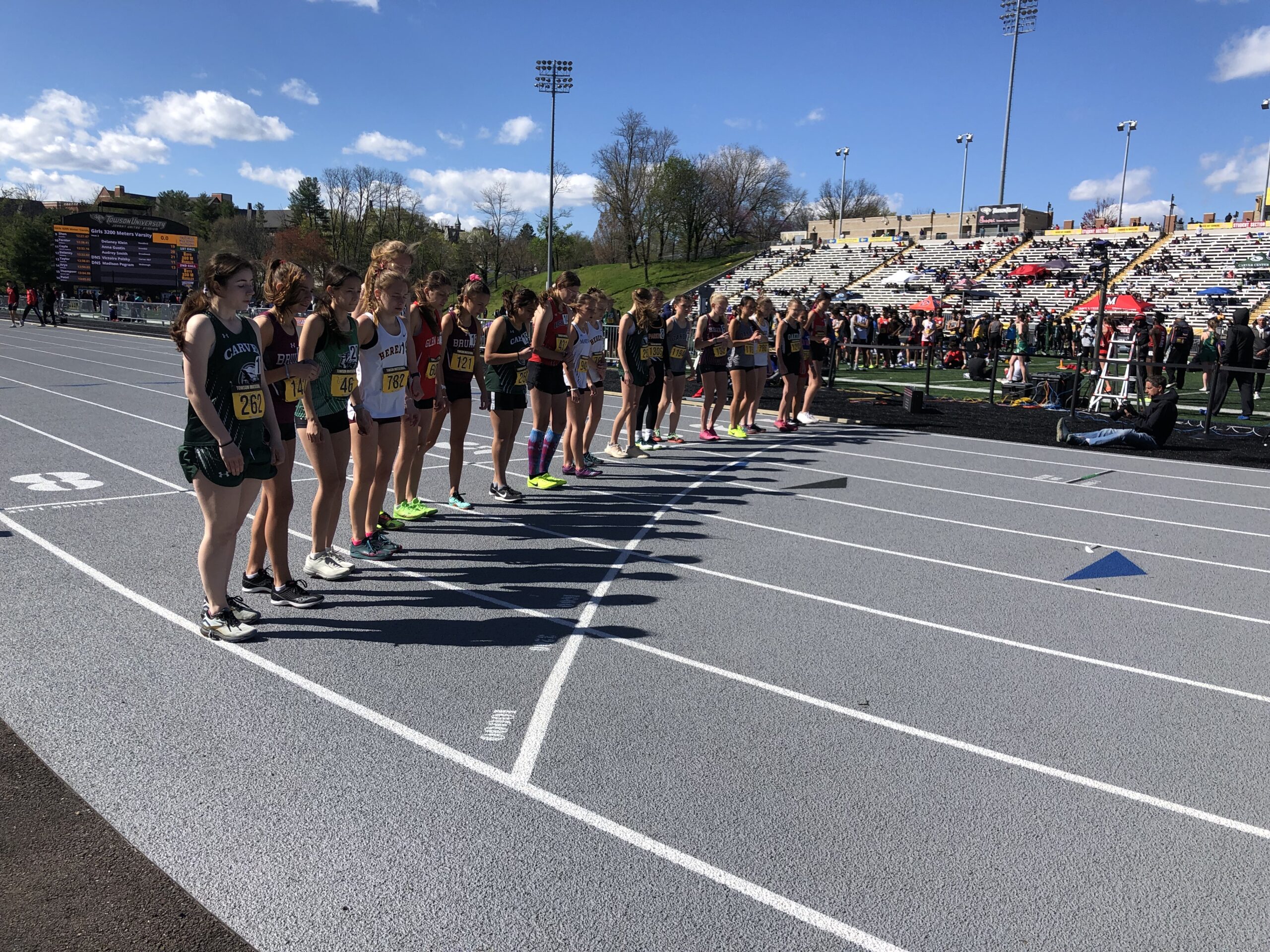 A group of people standing on top of a track.